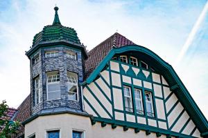 a black and white building with a tower at Traumhaft wohnen in Jugendstilvilla in Speyer