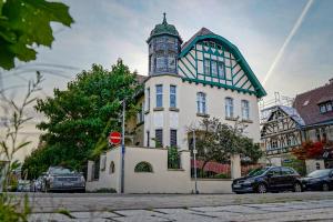 a building with a clock tower on top of it at Traumhaft wohnen in Jugendstilvilla in Speyer