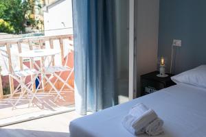 een slaapkamer met een bed en een balkon met een tafel bij B&B Interno12 in Follonica