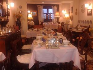 a dining room with tables with white table cloth at Ben View Guesthouse in Clifden