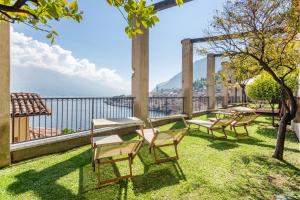 una fila di sedie seduta sull'erba su un balcone di Hotel Splendid Palace a Limone sul Garda