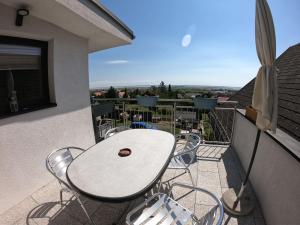 einen weißen Tisch und Stühle auf dem Balkon in der Unterkunft Ferienwohnung Pauli in Mörbisch am See