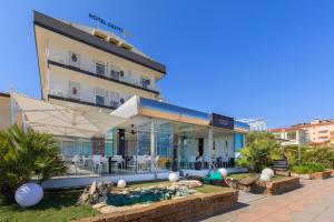 a hotel with a swimming pool in front of a building at Hotel Gritti in Lido di Jesolo