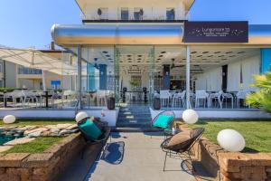 a group of chairs sitting outside of a building at Hotel Gritti in Lido di Jesolo