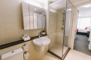 a bathroom with a sink and a shower at Newcastle Central Plaza Apartment Hotel Official in Newcastle