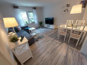 a living room with a couch and a table at Gemütliches, voll ausgestattetes Apartment in Halle an der Saale