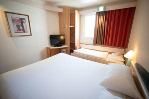 Кровать или кровати в номере ibis Fribourg