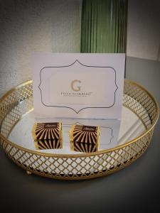 two pieces of chocolate on a table with a box at Villa Giardino Heritage Boutique Hotel Bol in Bol