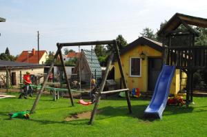 a group of kids playing on a playground at Landhotel Heidekrug in Dohma