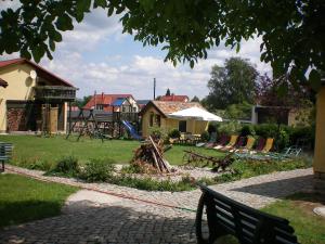 a park with a playground with chairs and a bench at Landhotel Heidekrug in Dohma