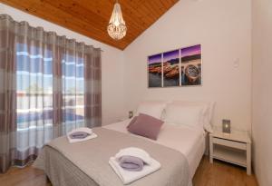 a bedroom with a bed with towels on it at Villa Anabella in Supetar