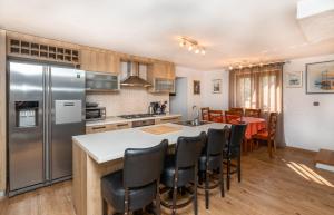 a kitchen with a refrigerator and a table with chairs at Villa Anabella in Supetar