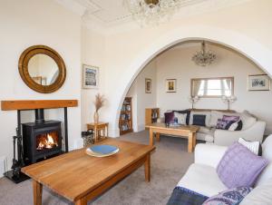 a living room with a fireplace and a couch at Bryn Ogwen in Bangor