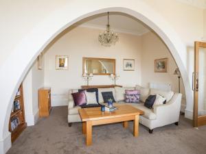 a living room with a couch and a table at Bryn Ogwen in Bangor