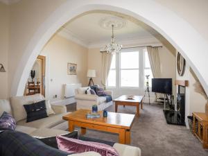 a living room with a couch and a table at Bryn Ogwen in Bangor