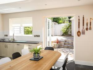 a kitchen and dining room with a wooden table and chairs at Bryn Ogwen in Bangor