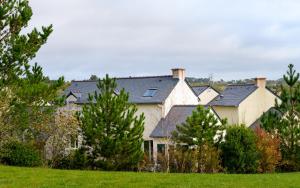 a group of houses with trees in a field at Lagrange Vacances Le Hameau De Peemor Pen in Crozon