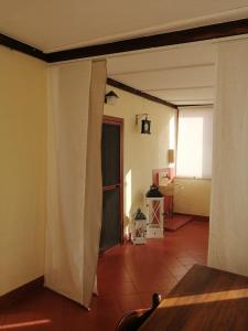 a living room with a table and a curtain at Lo Chalet in Ponte Galeria