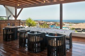 a long table with chairs and a view of the ocean at Finca Isolina Hotel Boutique - Adults Recommended in Mácher