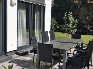 Une table à manger et des chaises sont disponibles sur la terrasse. dans l'établissement Ferienhaus Marie, à Erfurt