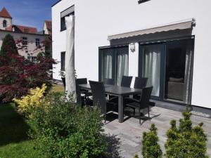 d'une terrasse avec une table et des chaises noires. dans l'établissement Ferienhaus Marie, à Erfurt