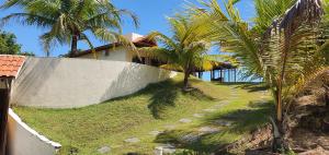 ein Haus mit Palmen an der Seite eines Hügels in der Unterkunft Villa Duna Icaraizinho beach front in Icaraí