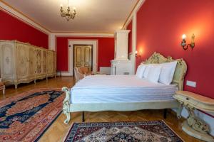 een slaapkamer met een groot bed met rode muren bij Clasic Haus Sighisoara in Sighişoara