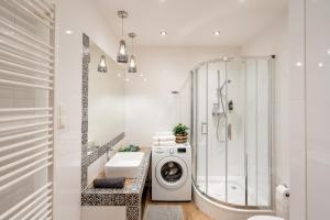 a bathroom with a washing machine and a shower at Sleeping in Krakow Main Market in Kraków