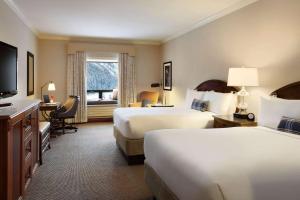 A bed or beds in a room at Fairmont Château Lake Louise