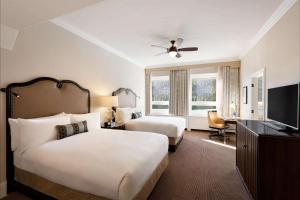 A bed or beds in a room at Fairmont Château Lake Louise