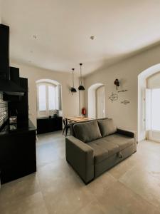 a living room with a couch and a table at Baixa-Mar Setúbal Miradouro in Setúbal