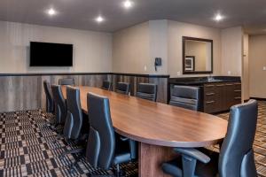 a conference room with a large wooden table and chairs at Best Western Plus Bridgewater Hotel & Convention Centre in Bridgewater