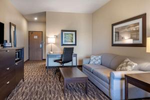 a living room with a couch and a chair in a hotel room at Best Western Plus Bridgewater Hotel & Convention Centre in Bridgewater