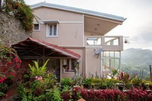 een huis met bloemen ervoor bij Syamantac Villa in Kodaikānāl