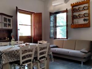 a living room with a table and a couch at Casa Margherita in Càbras