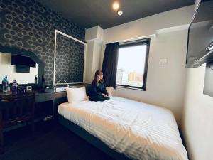 Кровать или кровати в номере Hotel Hulaton Fukuokahakata