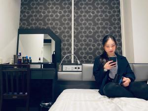 Кровать или кровати в номере Hotel Hulaton Fukuokahakata