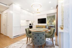 a kitchen and dining room with a table and chairs at Lux Apartment With A Terrace In Vilnius Old Town in Vilnius