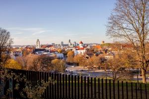 a view of a city from behind a fence at Lux Apartment With A Terrace In Vilnius Old Town in Vilnius