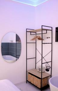 a bathroom with a mirror and a bath tub at The Apartment in Porto Santo Stefano