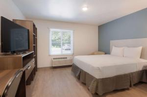 Rúm í herbergi á WoodSpring Suites Lynchburg VA