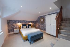 A bed or beds in a room at The Clarence Boutique Rooms