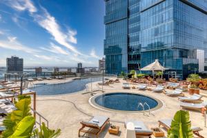 una piscina en la azotea de un edificio con tumbonas en InterContinental Luanda Miramar, an IHG Hotel, en Luanda