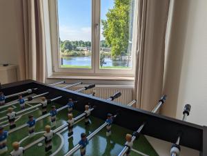 a group of dolls in a room with a window at HOMEY Apartments - Riverside - mit Weserblick und Parkplatz in Bremen