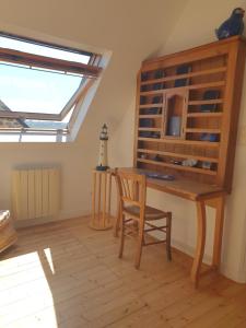 a room with a table and a chair and a window at Maison typique bretonne a 5 min de la plage a pied in Crozon