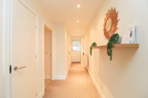 a hallway in a house with a mirror on the wall at A superb large 1 bedroom apartment in Ramsbottom in Ramsbottom