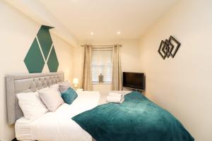 a bedroom with a large bed and a television at A superb large 1 bedroom apartment in Ramsbottom in Ramsbottom