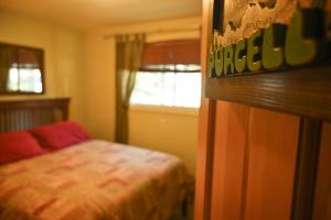 a bedroom with a bed and a window at Auberge Kicking Horse Guest House in Golden