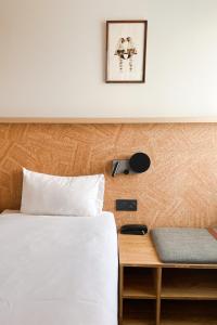 - une chambre avec un lit, une table et une photo dans l'établissement Greet Hotel Colmar, à Colmar