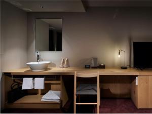 Giường trong phòng chung tại hotel androoms Sapporo Susukino